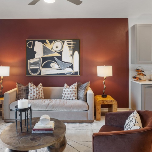 a living room with a couch and chair and table