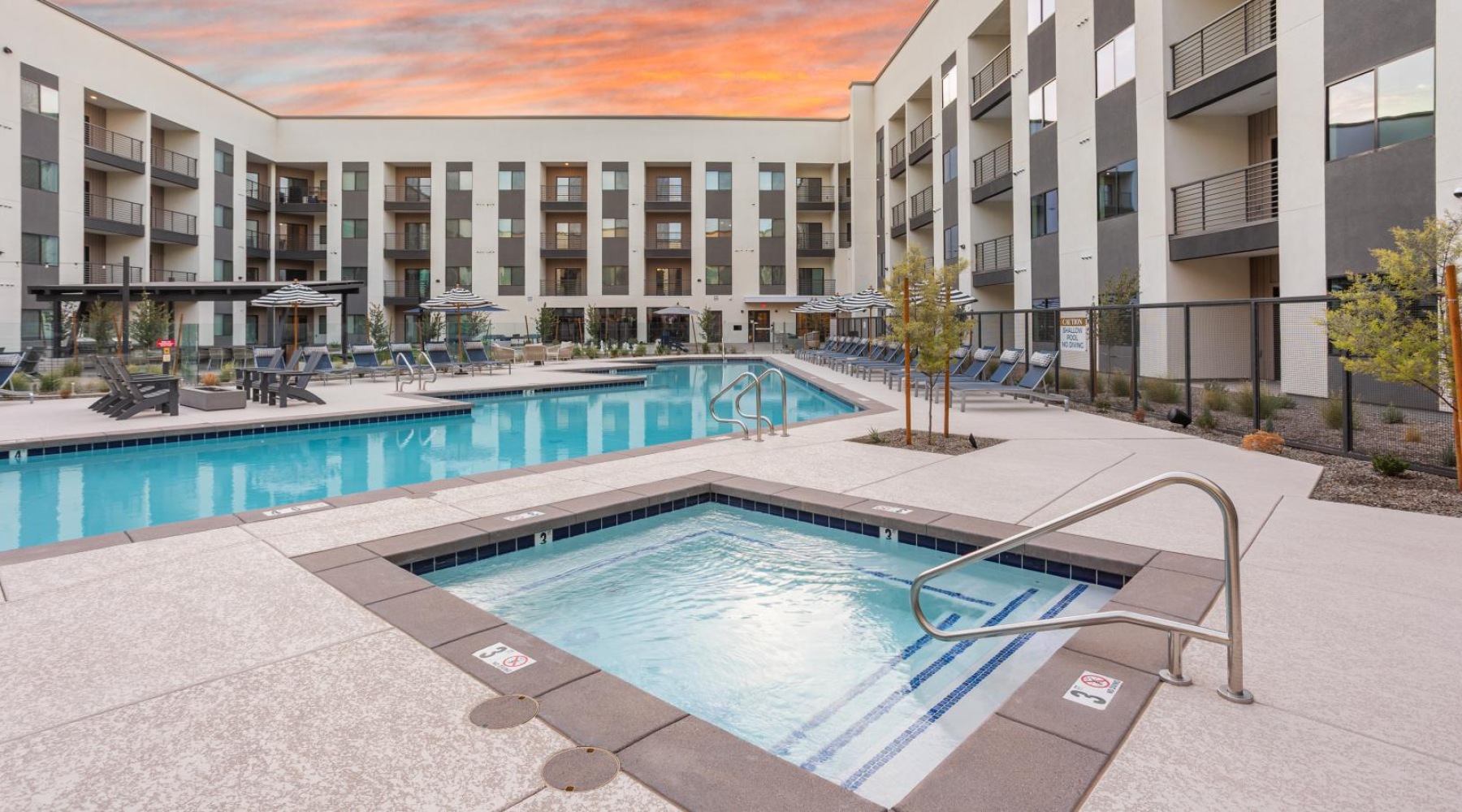 a swimming pool and a hot tub in a courtyard