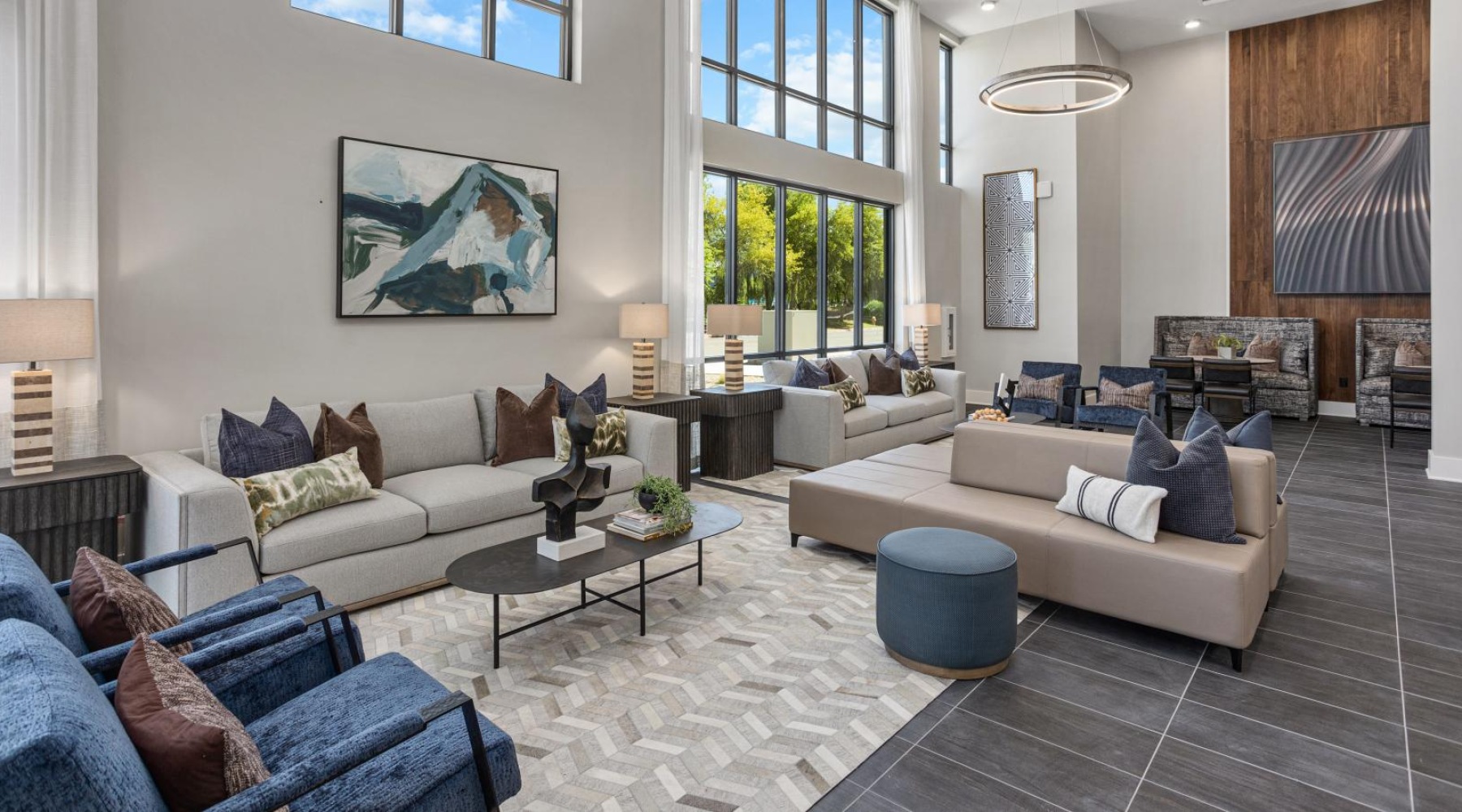 a lounge room with many couches and a large window